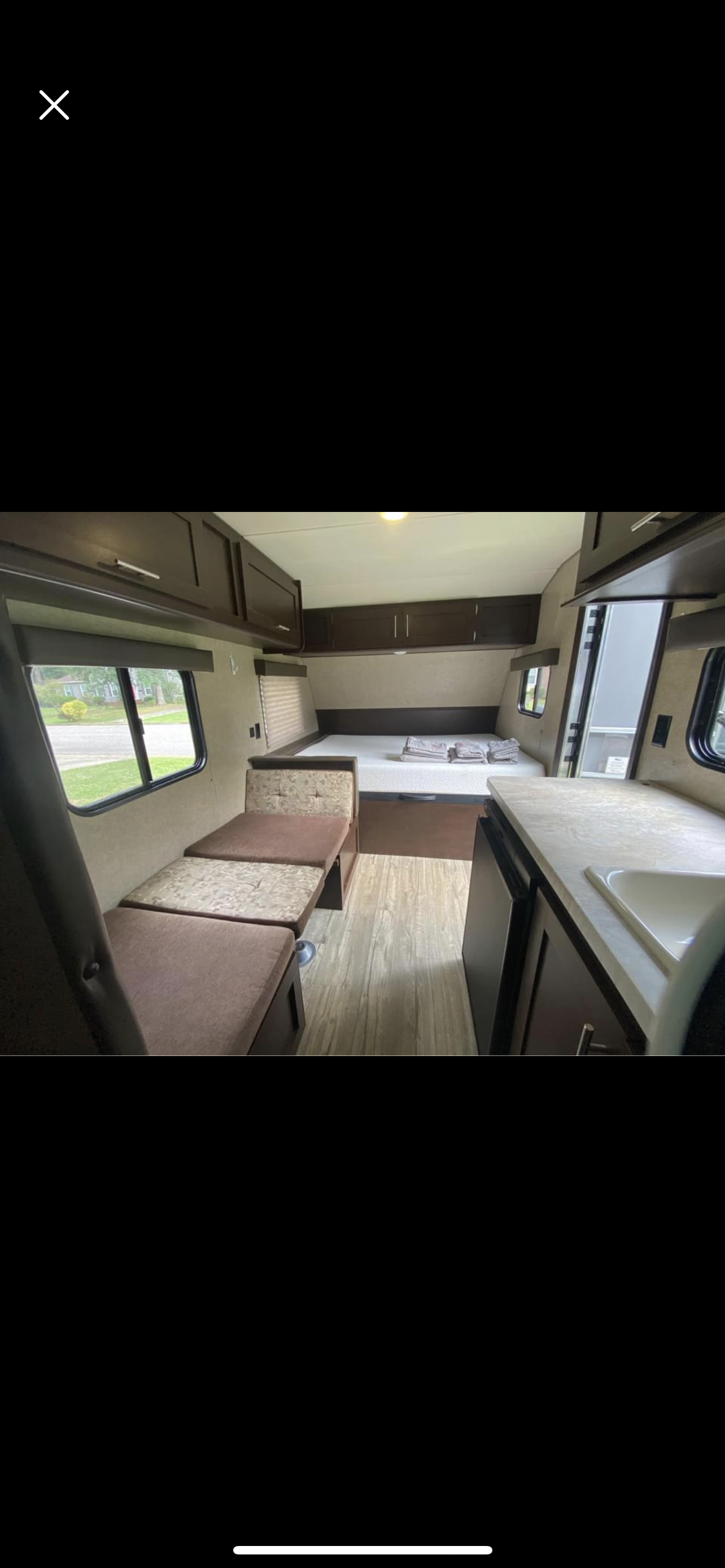 RV rental: Interior shows a clean bed with white mattress, convertible dinette, and kitchen area with sink. Ready for your trip!. Forest River Cherokee Wolf Pup 2016