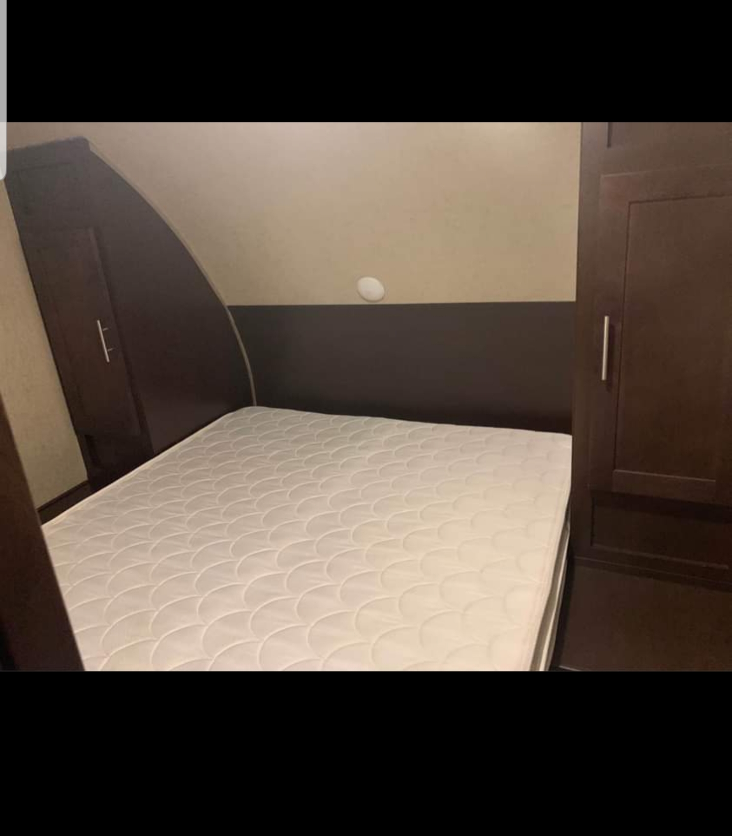 Comfortable RV rental bedroom with queen mattress and built-in storage. Ideal for travel.. Forest River Grey Wolf 2017