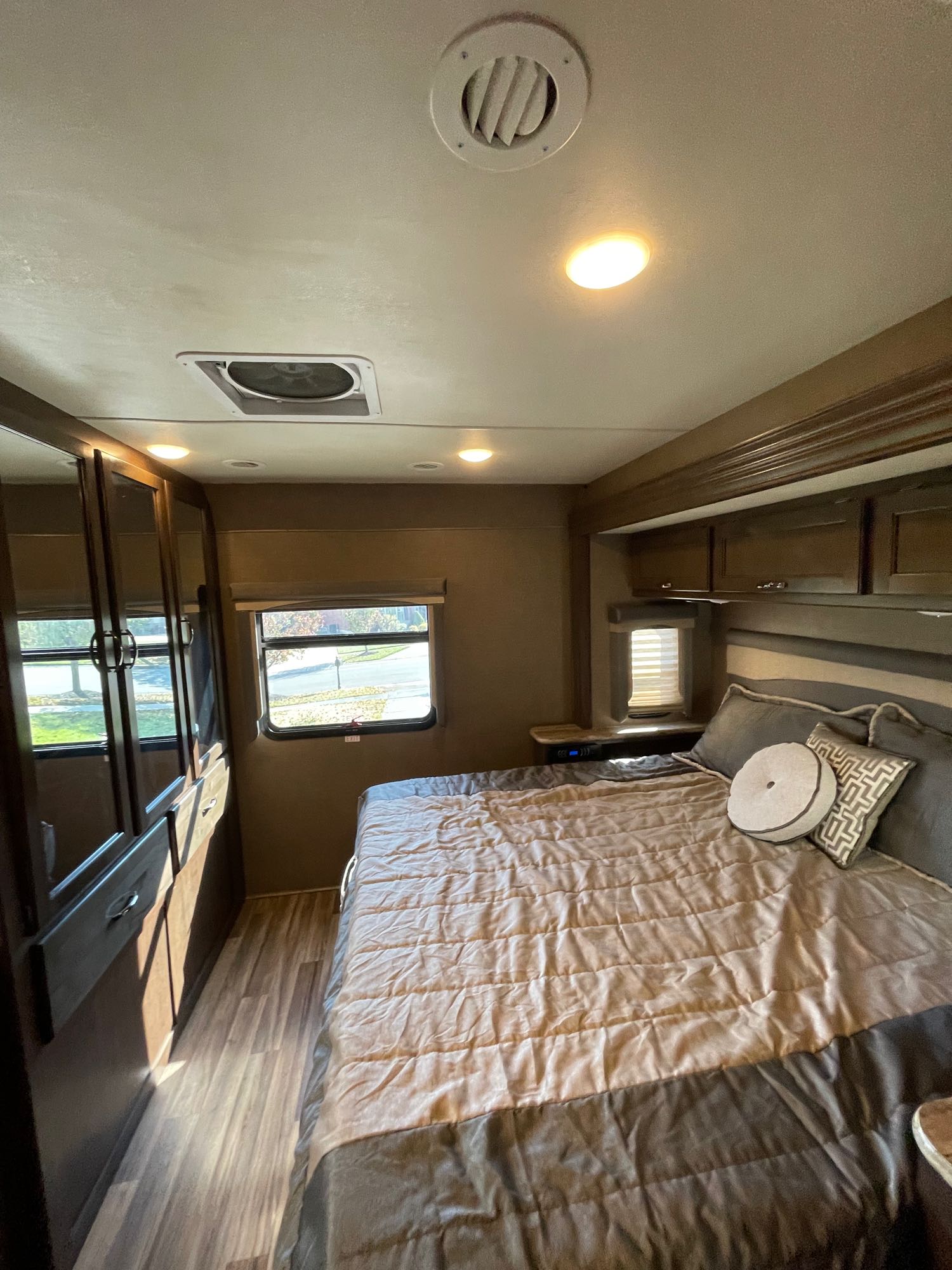 Experience comfort in this RV rental bedroom with a cozy bed, wardrobe, and ample storage, perfect for your travels.. Thor A.C.E. 2017