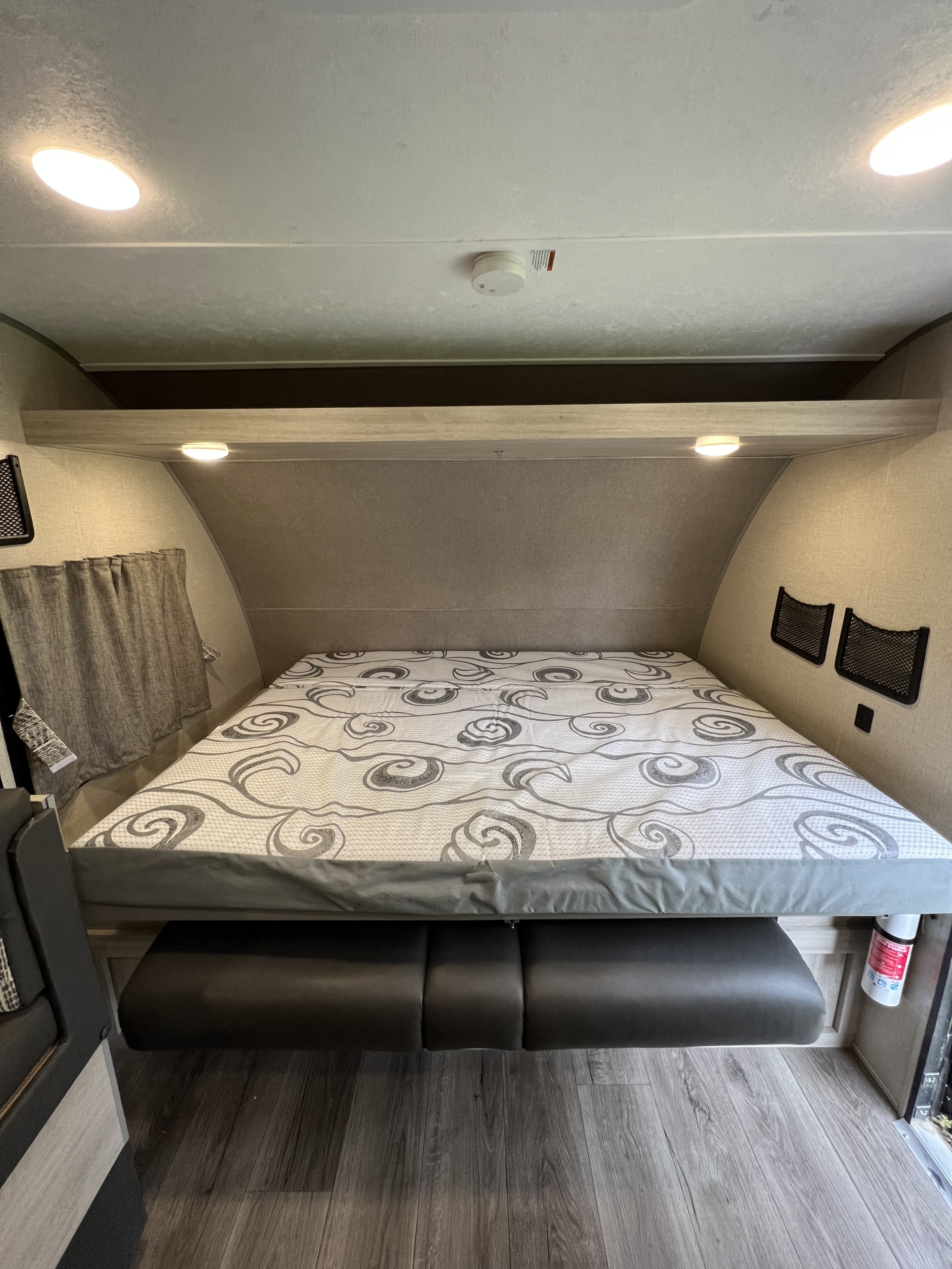 This RV rental offers a convertible bed/dinette area, complete with a patterned mattress, overhead lights, and handy storage nets.. Coachman Catalina Catalina Summit Series 7 184BHS 2022