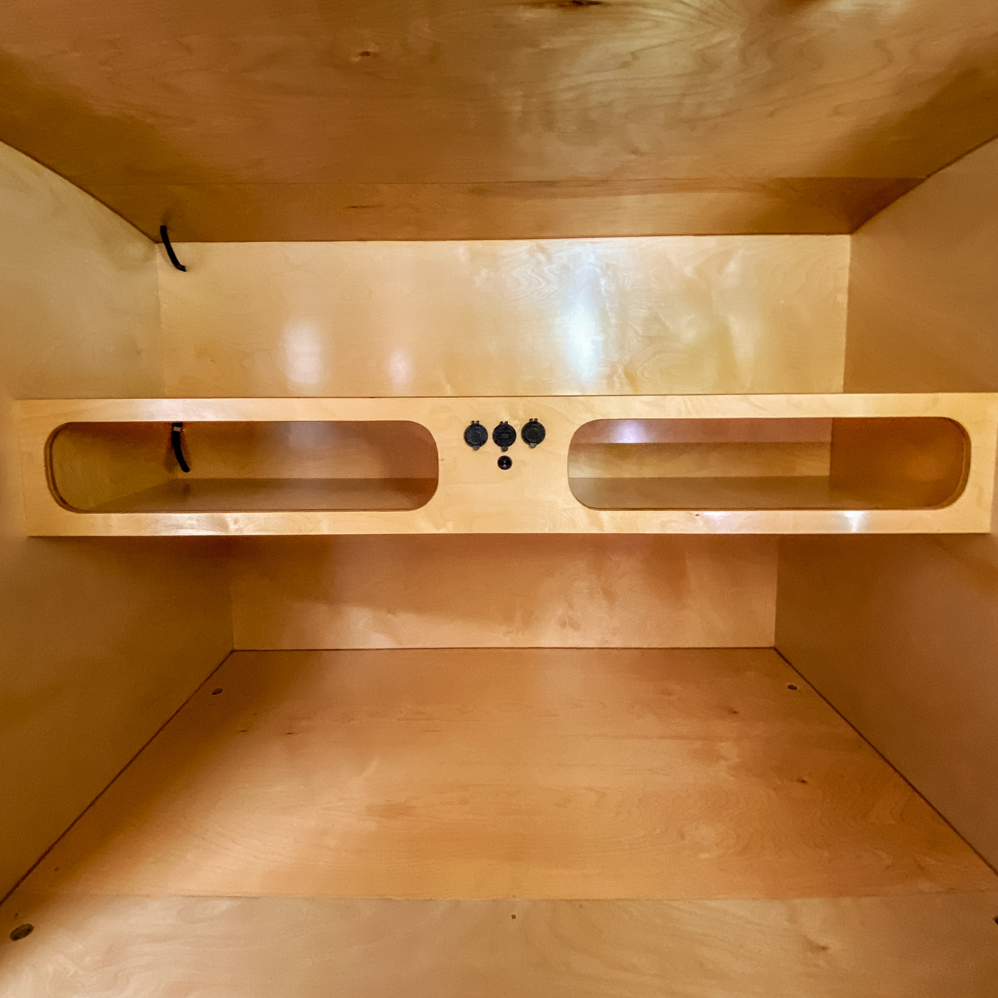 RV rental: Wooden cabinet with a shelf & integrated power outlets, providing convenient storage and charging.. Wander Tears Renegade LT 2021