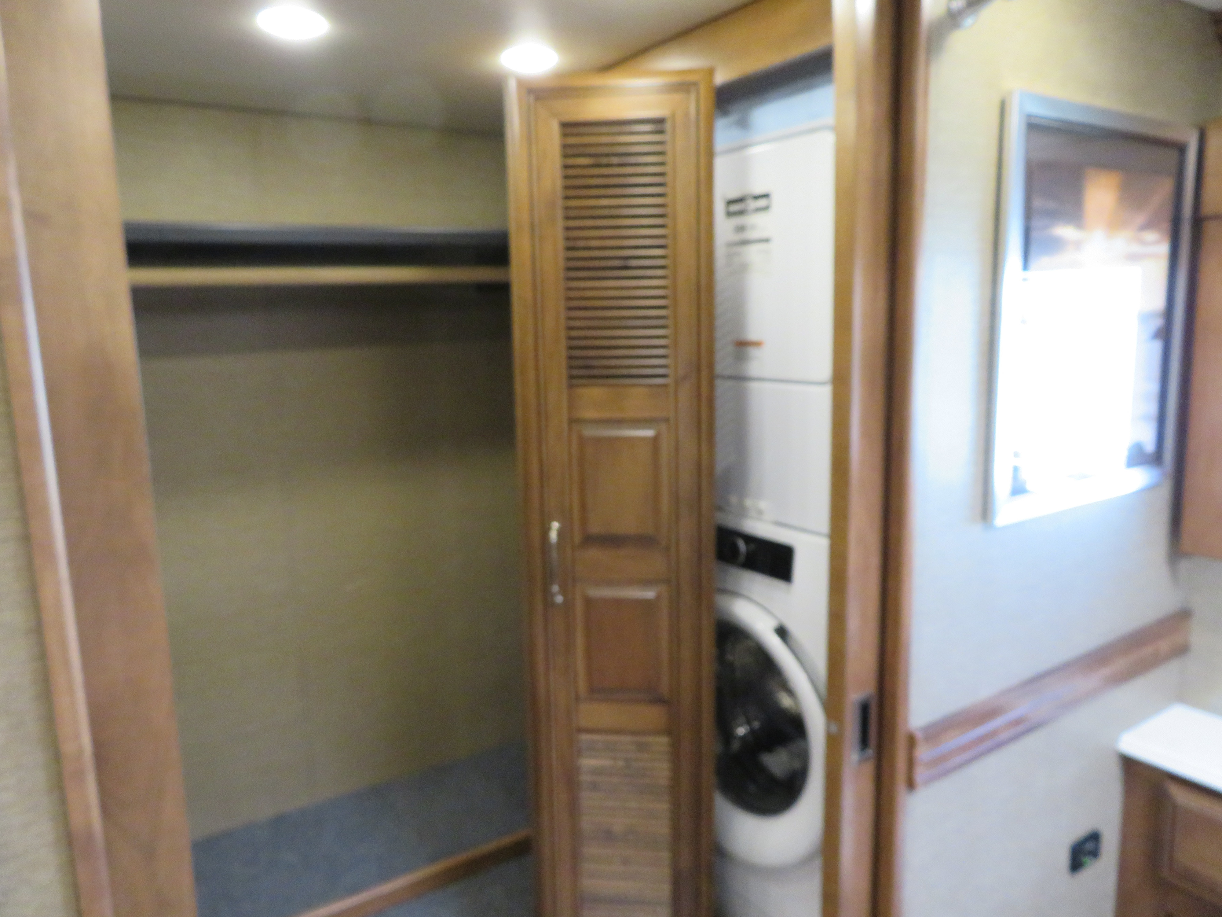 RV rental interior: an open closet offers storage, and a stacked washer/dryer simplifies laundry needs.. Monaco Signature 2019