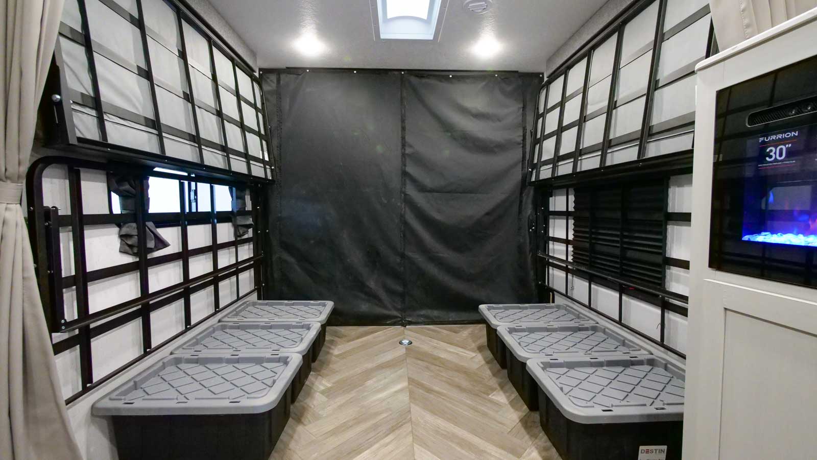 Flexible RV rental interior with fold-up bunk beds, floor storage, and a rear garage space for gear.. Forest River Wildwood FSX PLATINUM Toy Hauler 2022