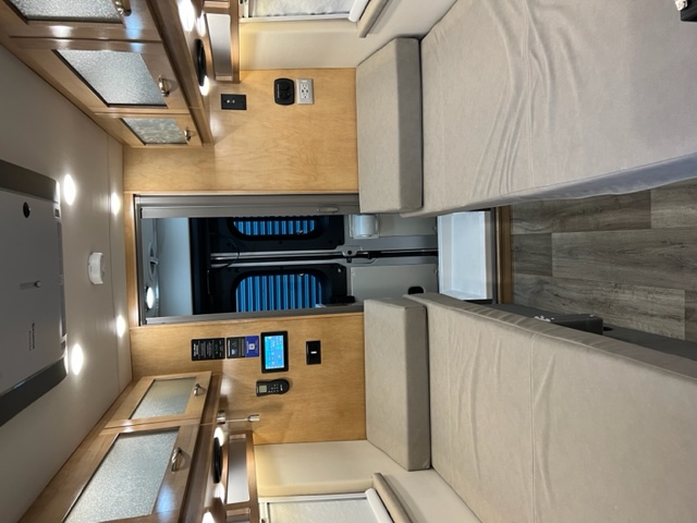 RV rental: Bright interior featuring comfortable bunks, wooden cabinetry, and tech controls for your journey.. Forest River Coachmen Nova 2022