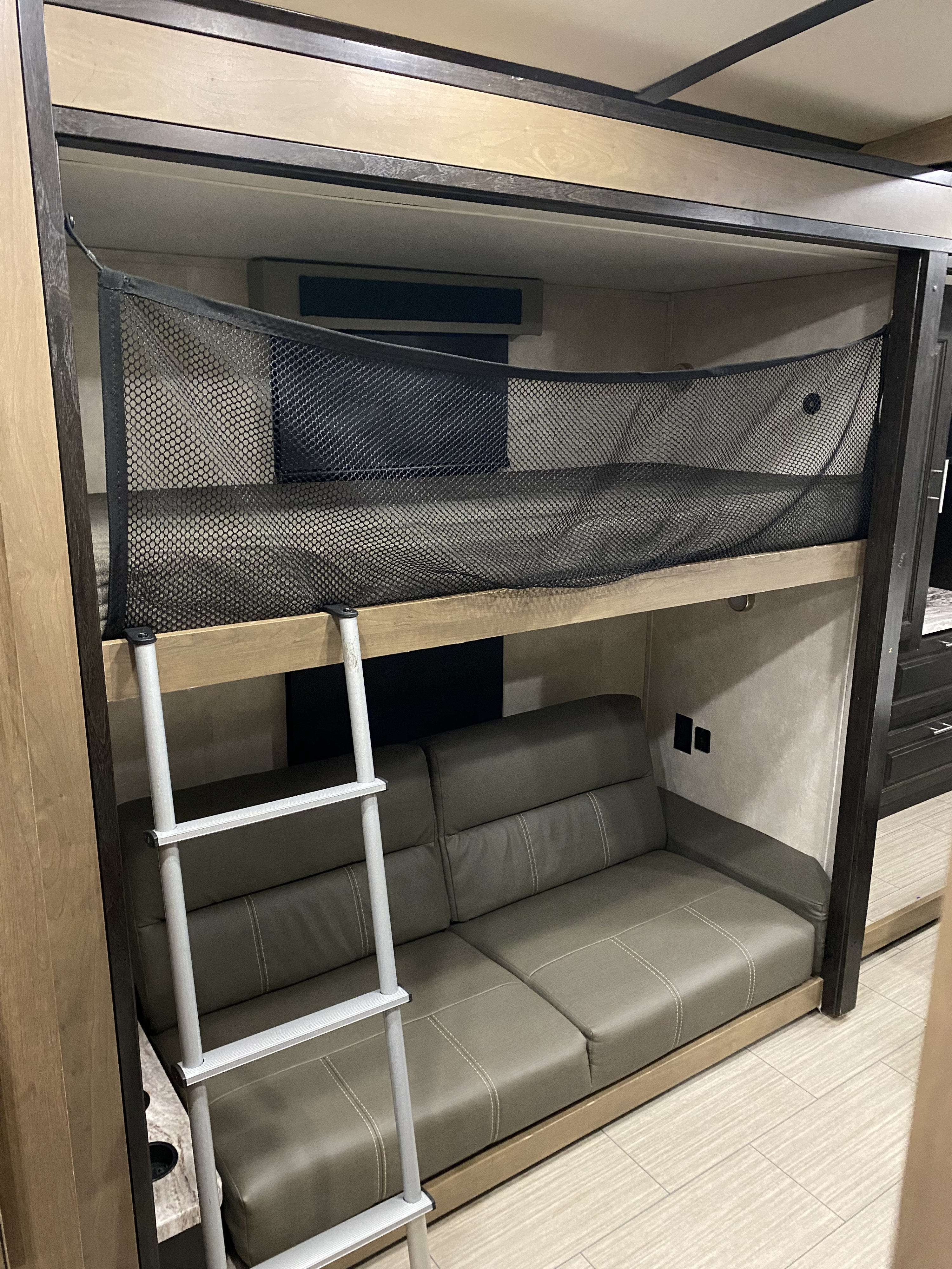 Comfortable RV rental interior featuring a bunk bed with safety net and a versatile convertible sofa.. FR3 FR3 Motorhome 2021