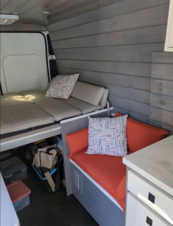 RV rental: Comfy interior with convertible bed, bench seating, and wood panels.. Other Other 2021