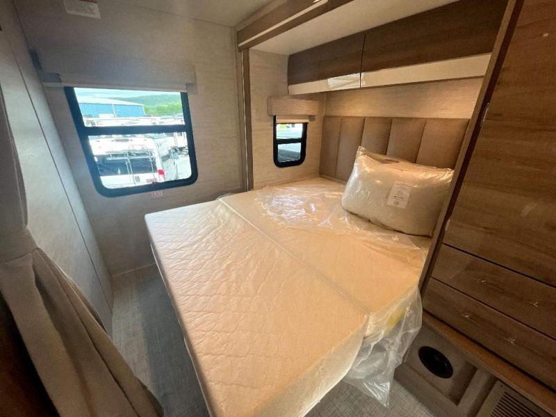 New RV rental bedroom: plastic-wrapped mattress, padded headboard, and built-in storage cabinets. Ready for travel!. Entegra Coach Qwest 2023