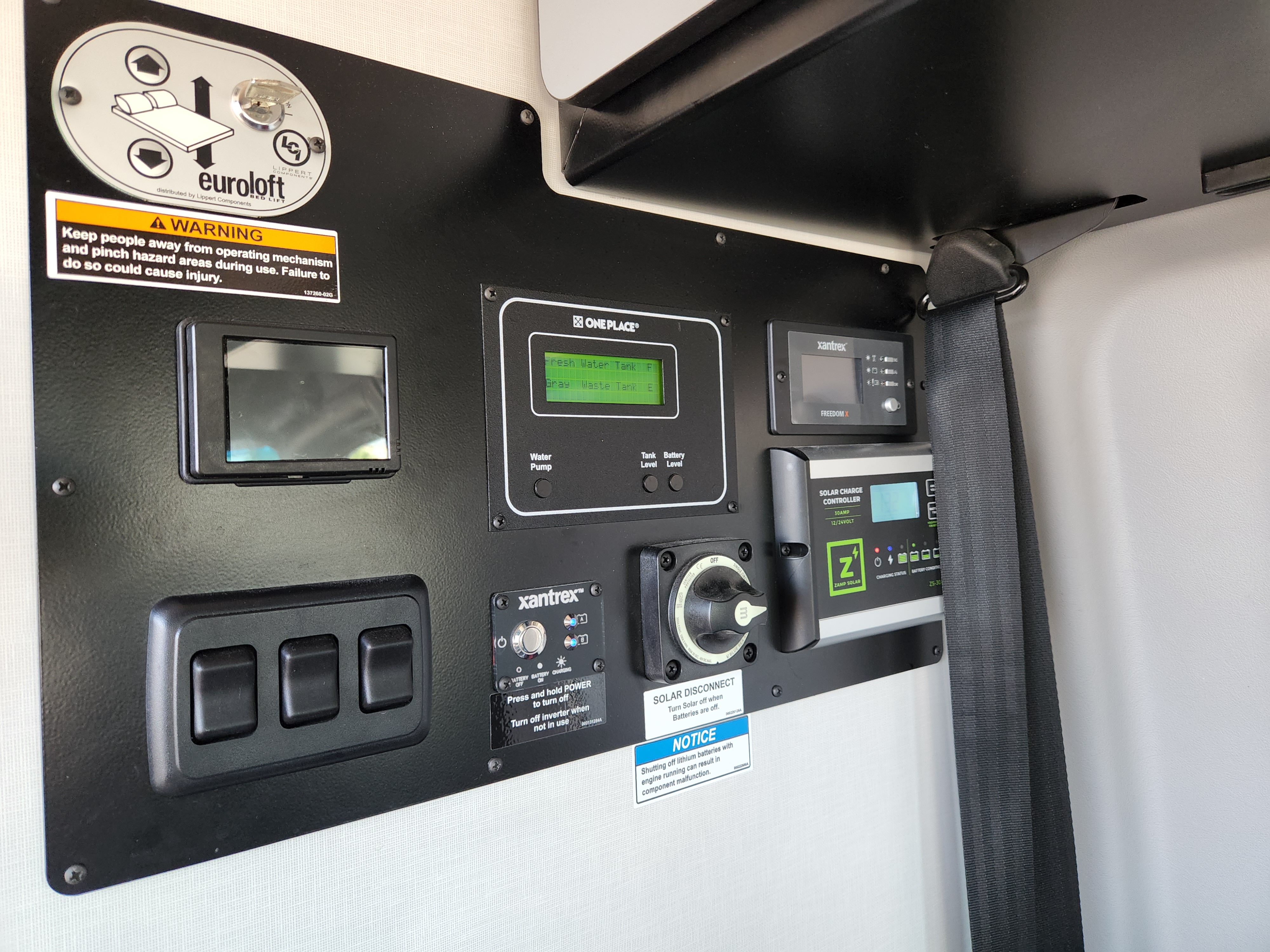 Detailed RV rental control panel showing tank levels, solar charging, inverter, and Euroloft bed lift operation.. Winnebago Revel 2022