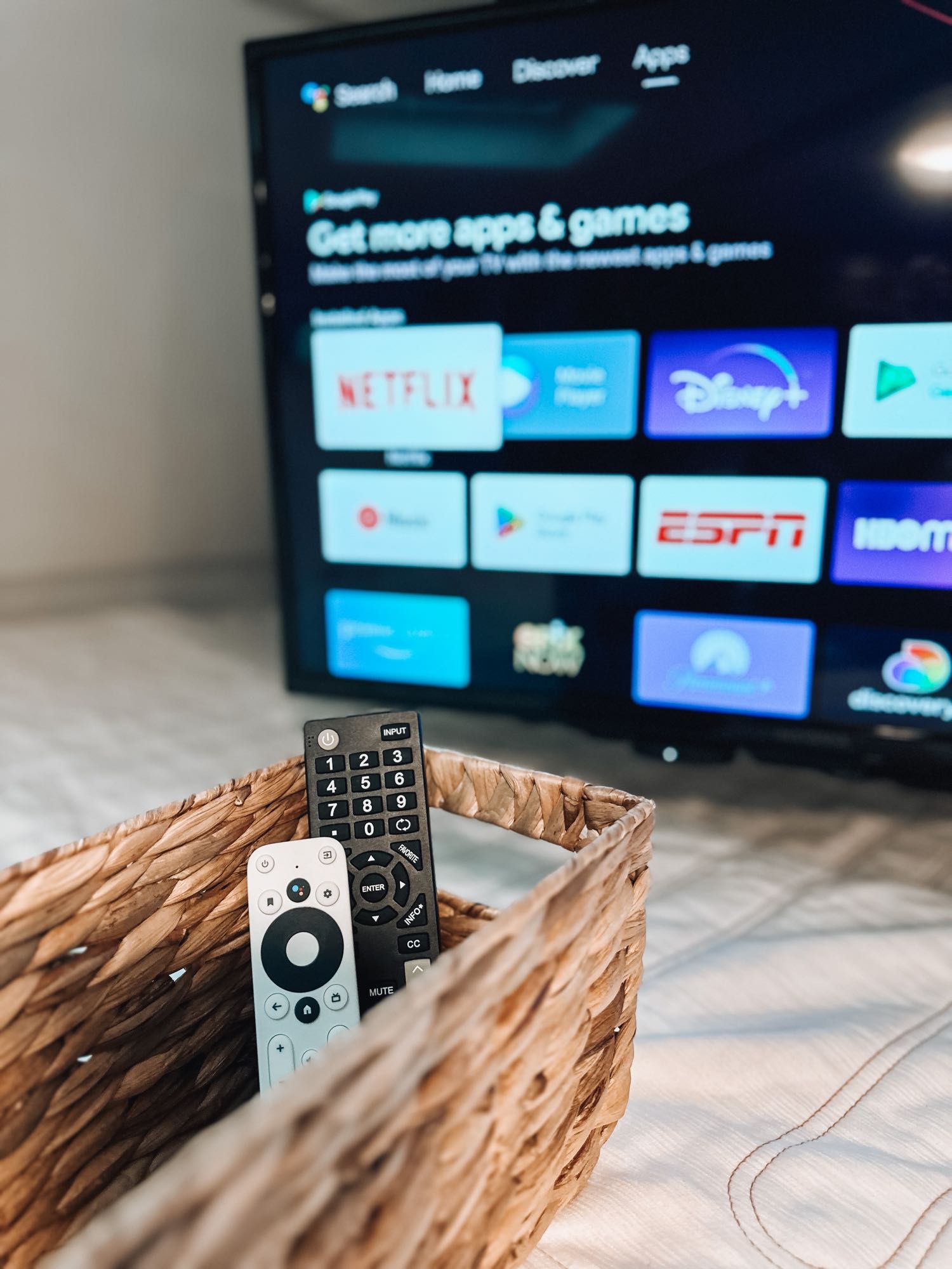 RV rental ready for entertainment: Smart TV showing apps like Netflix and Disney+, with remotes nestled in a wicker basket.. Winnebago Spirit 2019