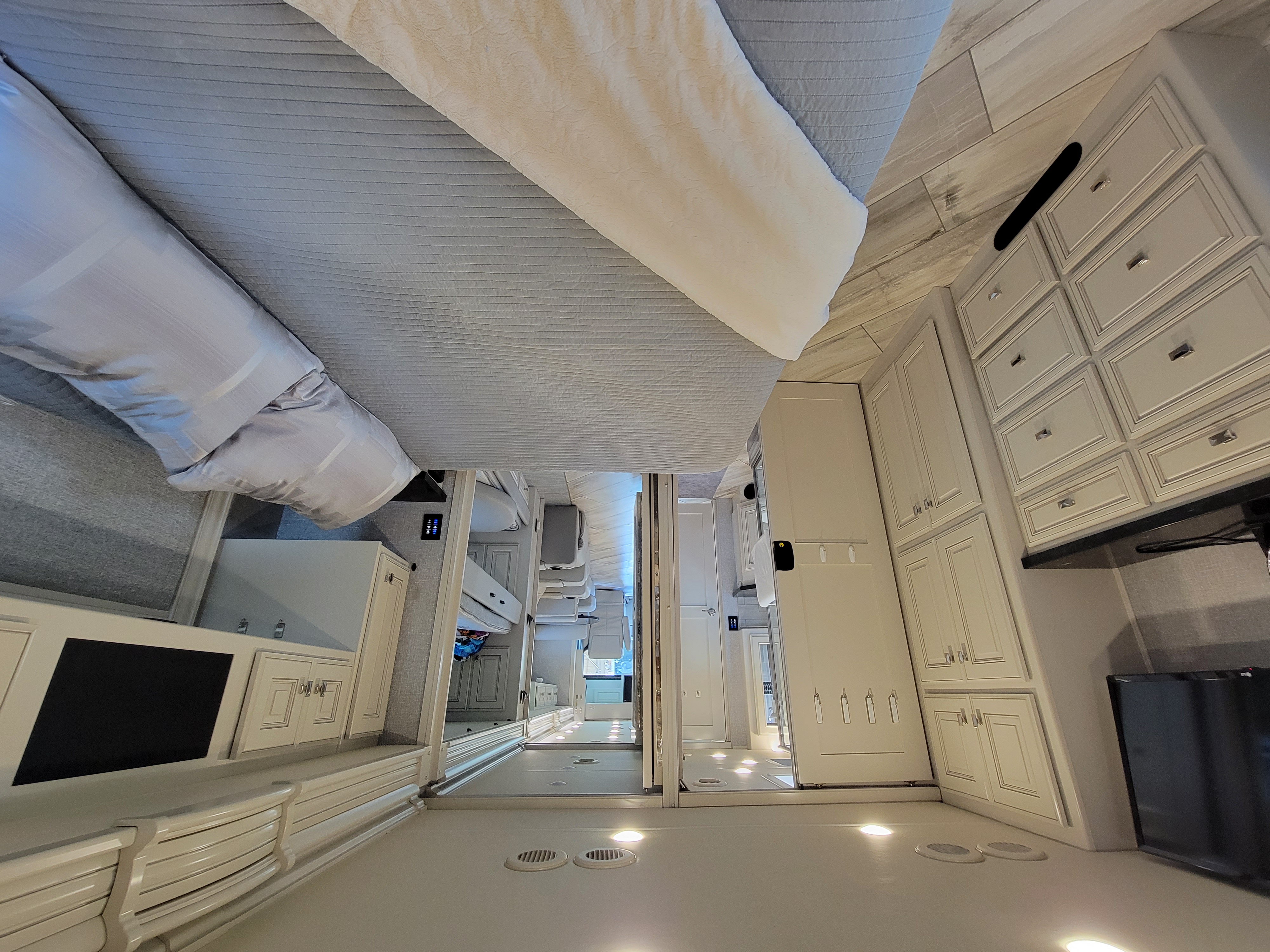 Spacious and modern RV rental interior, showcasing a comfortable bed, ample storage, and bright ambient lighting.. Fleetwood Other 2022