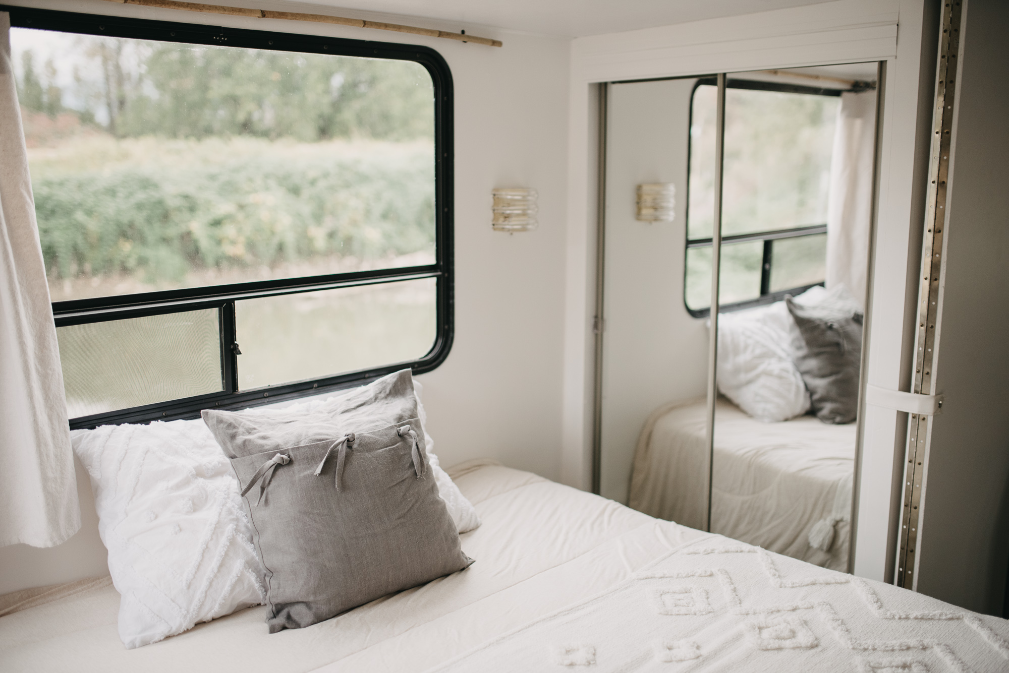 Relax in this cozy RV rental bedroom. Features a comfortable bed, mirrored closet, and a large window overlooking nature.. Glendale Royal Classic 1999