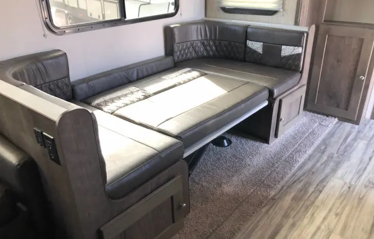 Modern RV rental living space: a gray dinette easily converts to a cozy bed.. Cruiser RV MPG Ultra Lite 2020