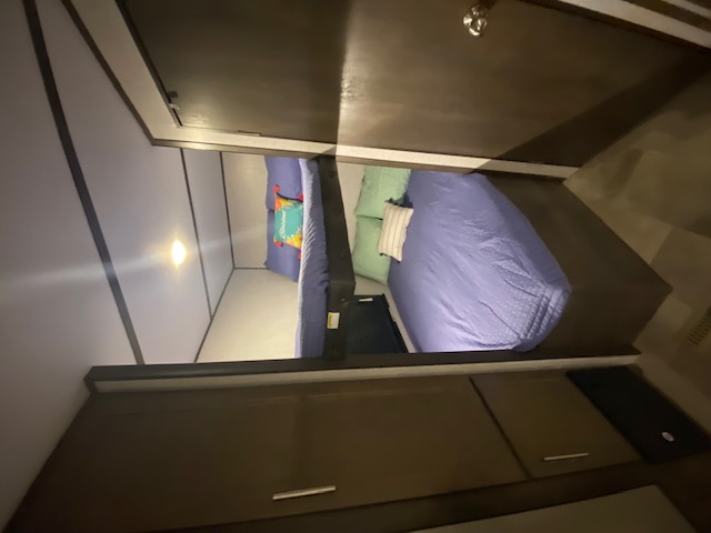 Cozy RV rental bedroom featuring a comfy lower bed and an upper bunk, ideal for family trips.. Keystone RV CMMM262BH21 2021