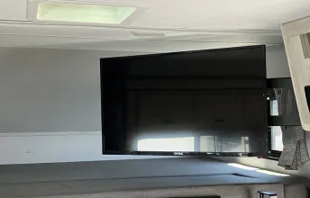 RV rental bunk area featuring a wall-mounted TV. Perfect for entertainment in your travel trailer.. Forest River Sunseeker LE 2022