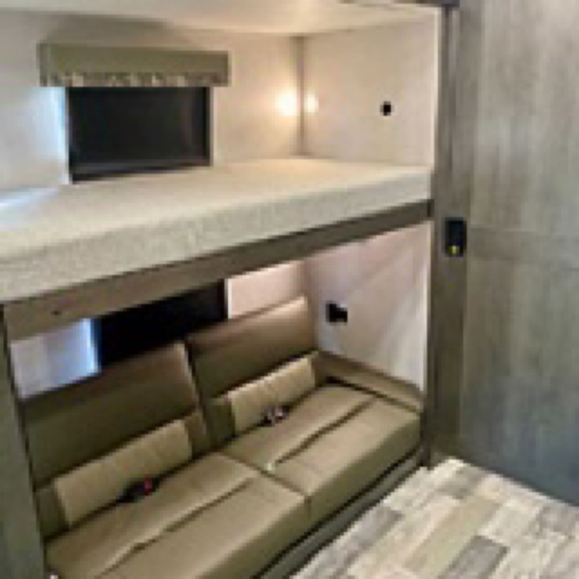 RV rental: Space-saving interior features bunk beds above a sofa, with a window & TV.. Forest River Fr3 2021