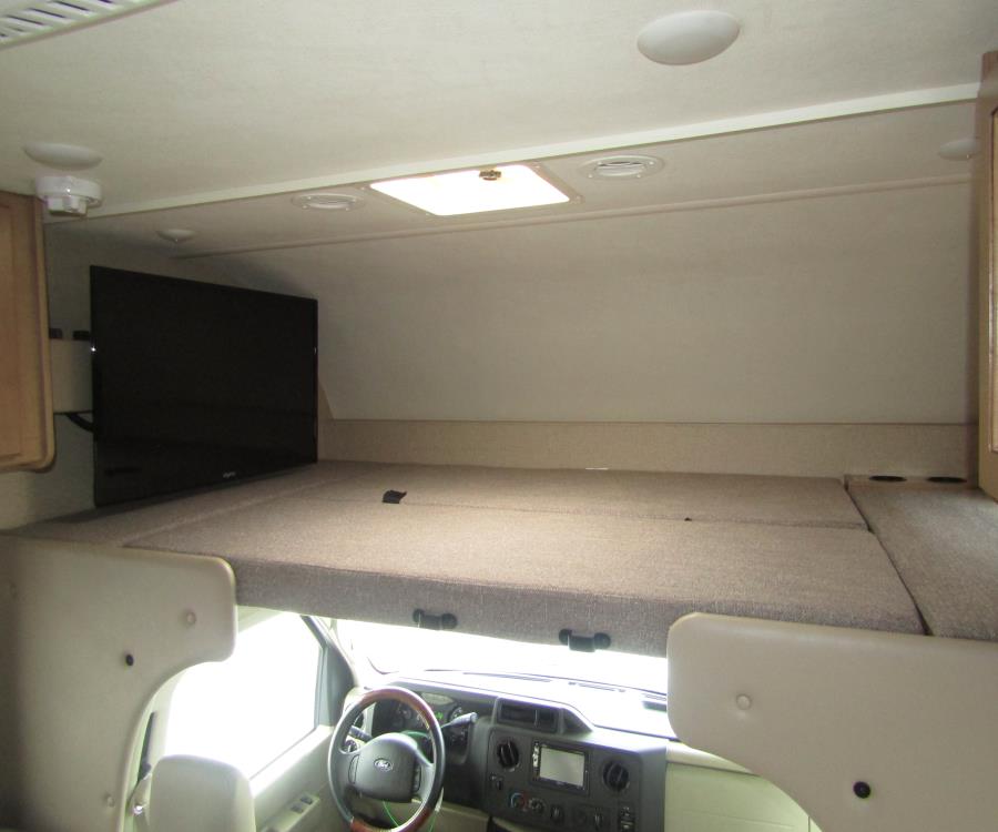 This rv rental features a large over-cab bunk with a TV, providing a cozy sleeping area above the cab.. Thor Motor Coach Freedom Elite 2019