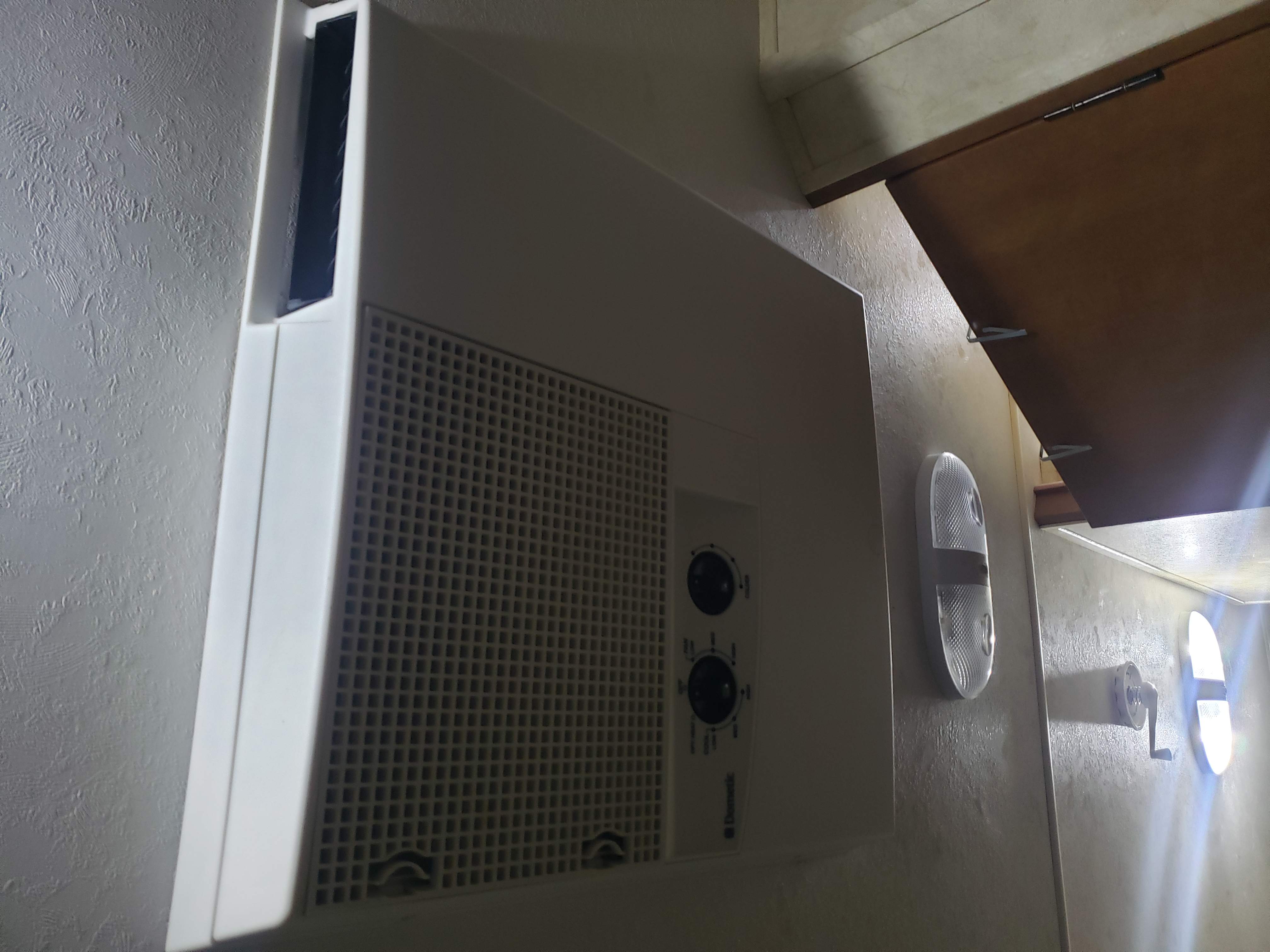 Dometic RV air conditioner and cabin lights are visible in this RV rental interior, offering climate control and lighting.. Coachmen Apex 2012