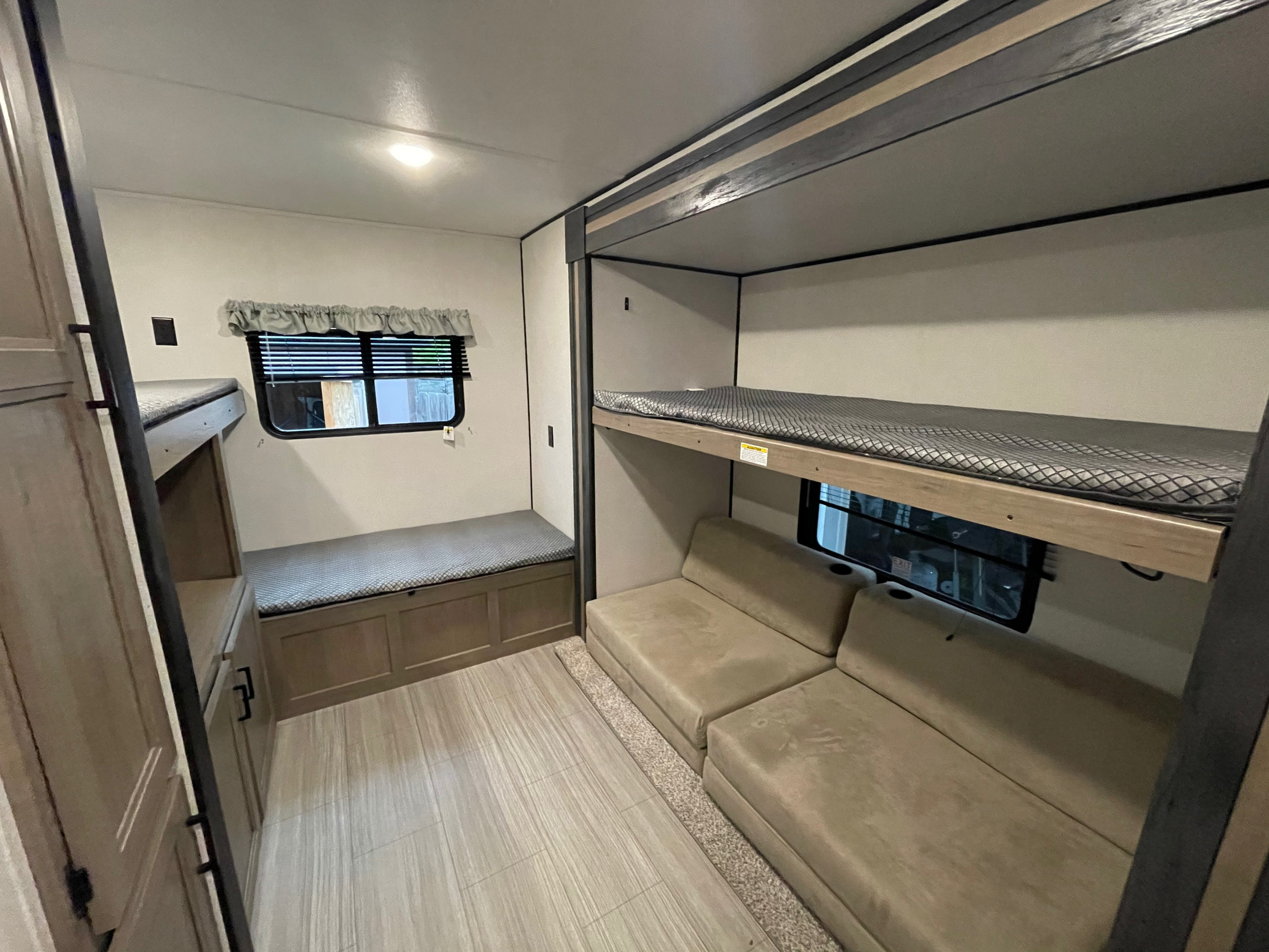 RV rental with versatile bunk beds, a convertible sofa, and bench seating, ideal for compact travel and family comfort.. Keystone RV Hideout 2021