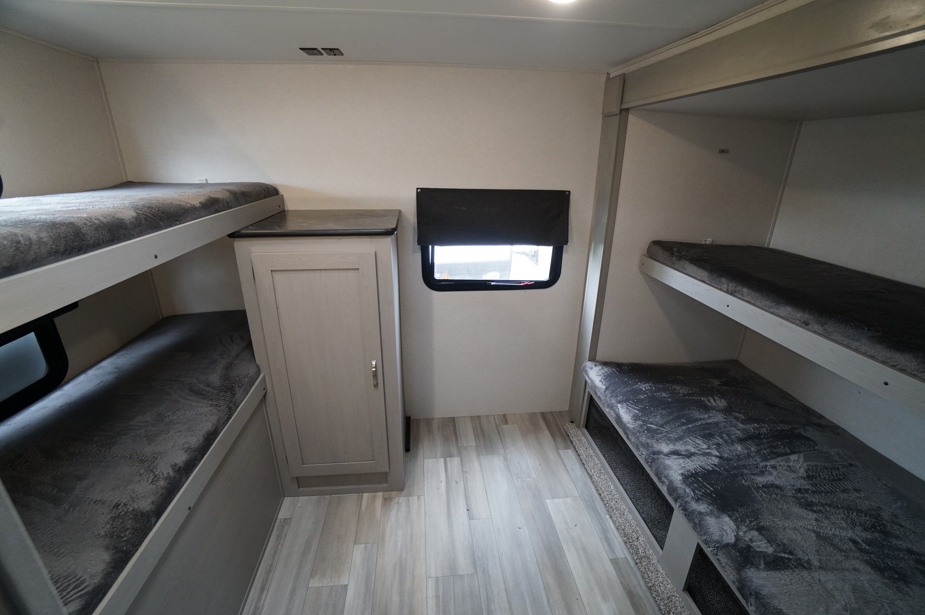 RV rental interior featuring a bright, spacious bunkhouse with multiple sleeping areas and built-in storage.. Prime Time Tracer 31BHD 2023