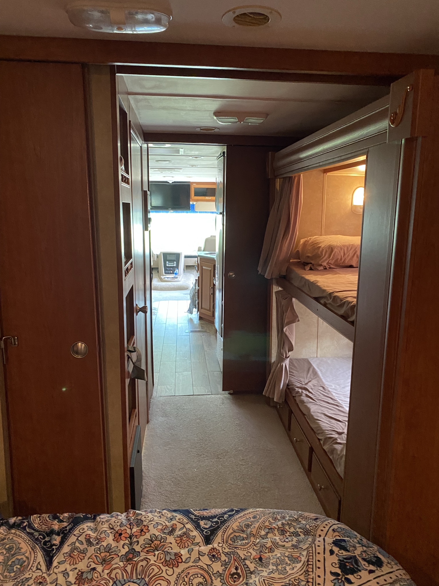 RV rental interior: A hallway leads past bunk beds with curtains on the right towards the front cab area.. Georgetown Georgetown Motorhome 2010