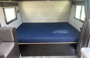 Spacious RV rental bedroom interior with a large, comfortable bed and windows for a bright sleeping area.. Jayco Jay Flight SLX Baja Edition 2022