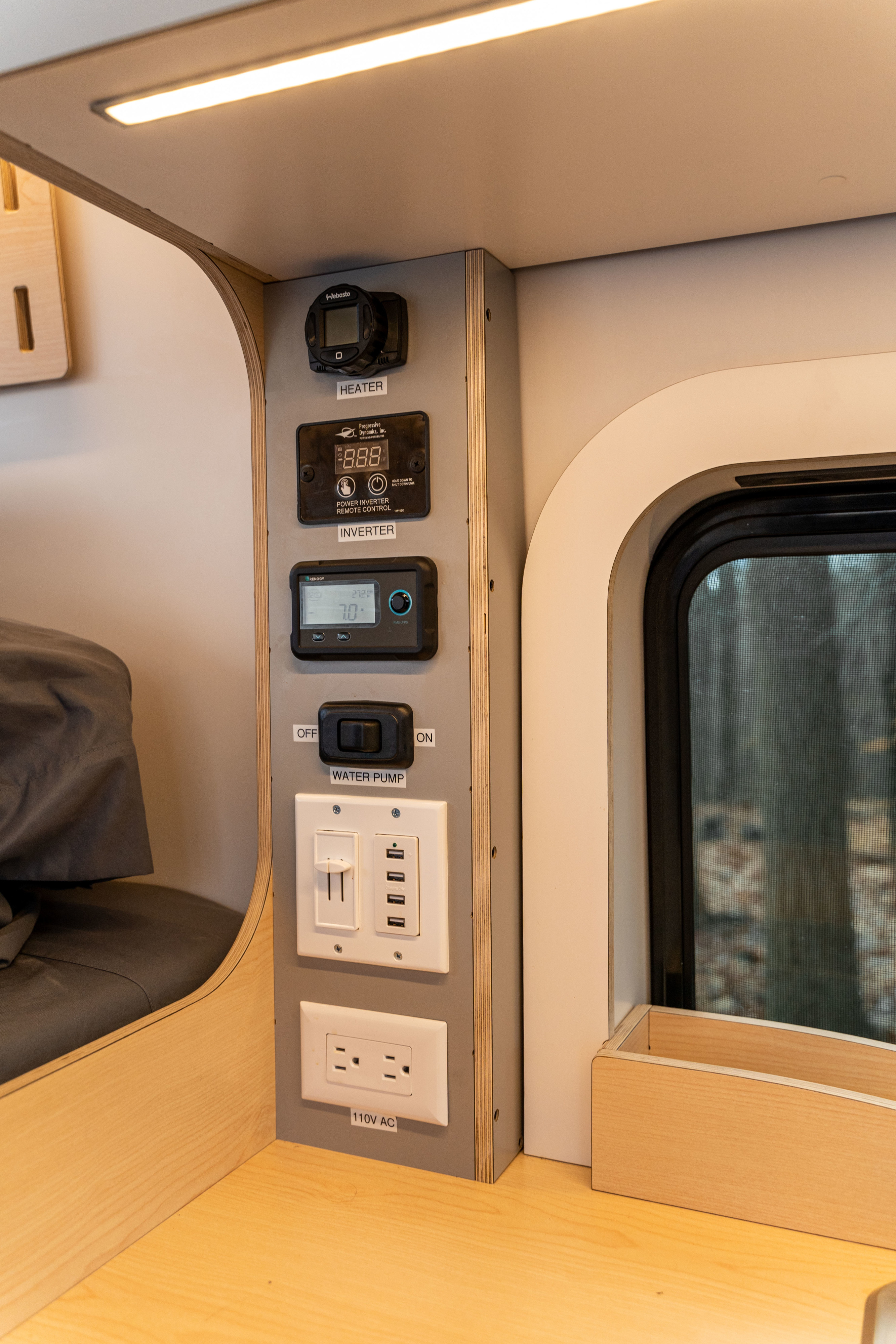 This RV rental's detailed control panel features a heater, inverter, water pump, USB, and 110V AC outlets.. Other Other 2022
