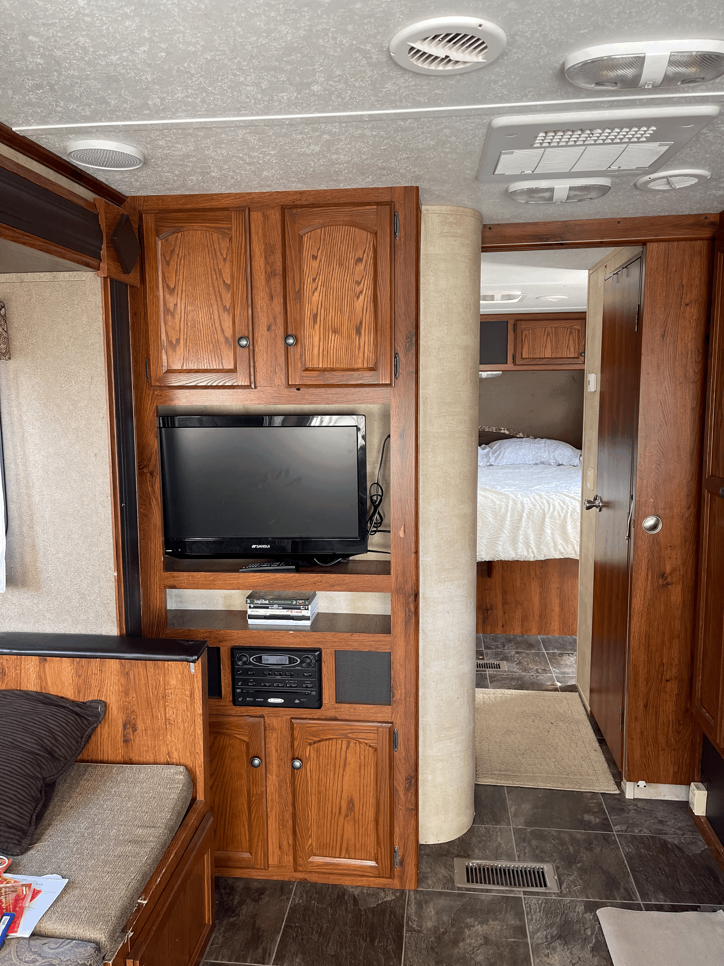 RV rental: well-appointed interior showing entertainment center, ample wood storage, and bedroom access.. Keystone RV Hideout 2013