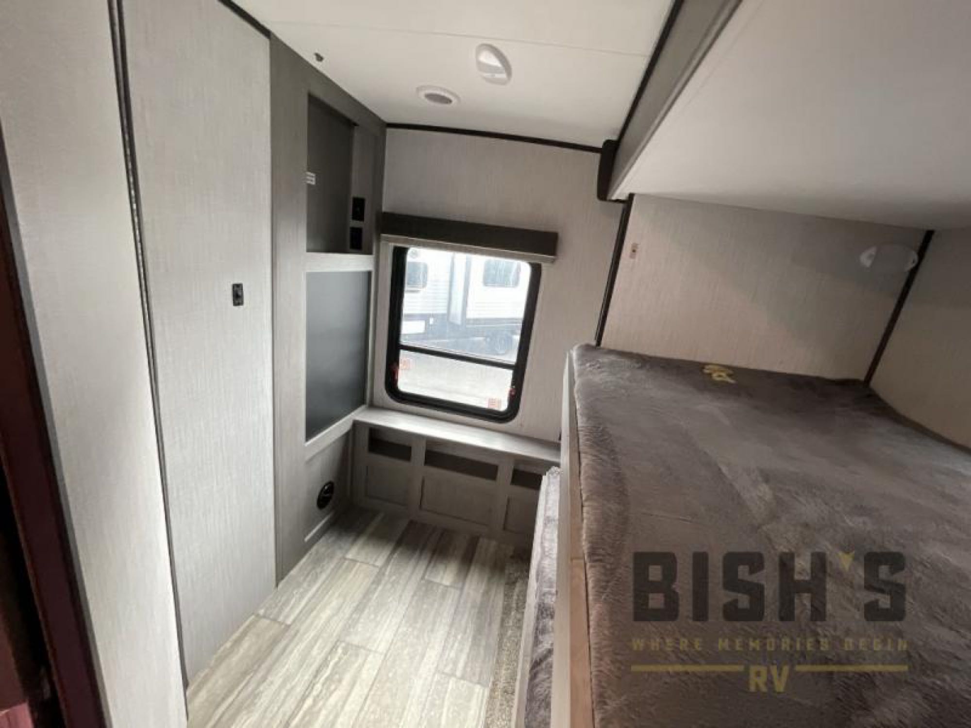 Spacious RV rental interior featuring comfortable bunk beds, built-in storage, and bright windows. Ideal for family trips.. Heartland North Trail 2021