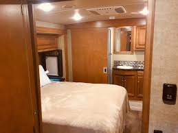Queen bed with bath/shower at the rear. Windows on both sides of the head of the bed. Winnebago Vista LX 2017