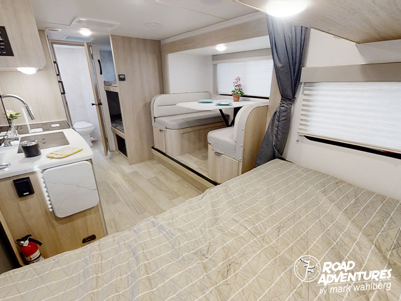Modern RV rental interior with bed, kitchen, dinette, bathroom, and bunk beds for compact travel adventures.. Winnebago Micro Minnie 2100BH 2023