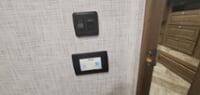 RV rental wall controls: a digital thermostat below a light switch. Manage comfort in your mobile home.. Georgetown GT5 2021