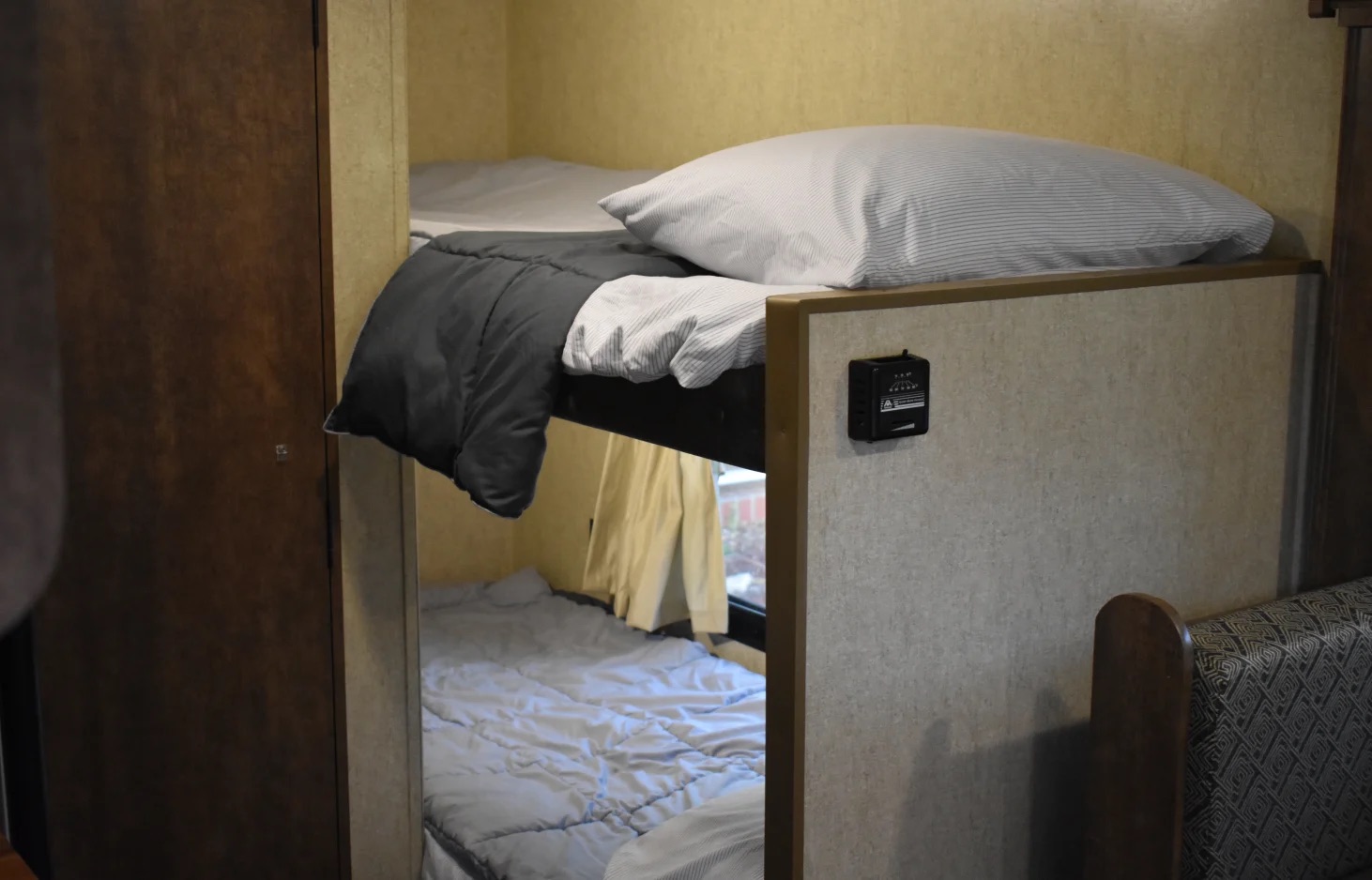 Inside an RV rental: two bunk beds with bedding, offering a cozy sleeping setup for travel adventures.. Starcraft Autumn Ridge Mini 2017