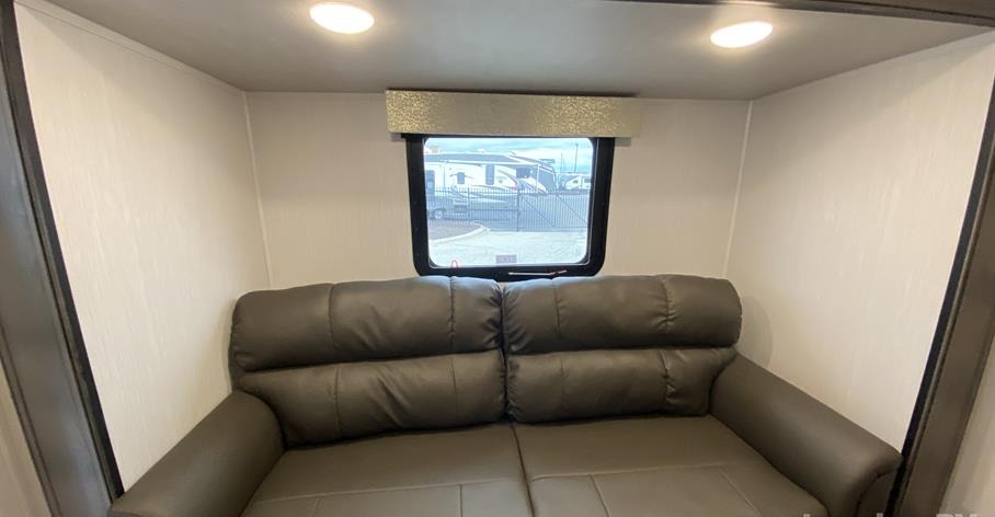 RV rental interior: Comfortable dark gray sofa, window with outdoor view, and bright ceiling lights.. Forest River Other 2022