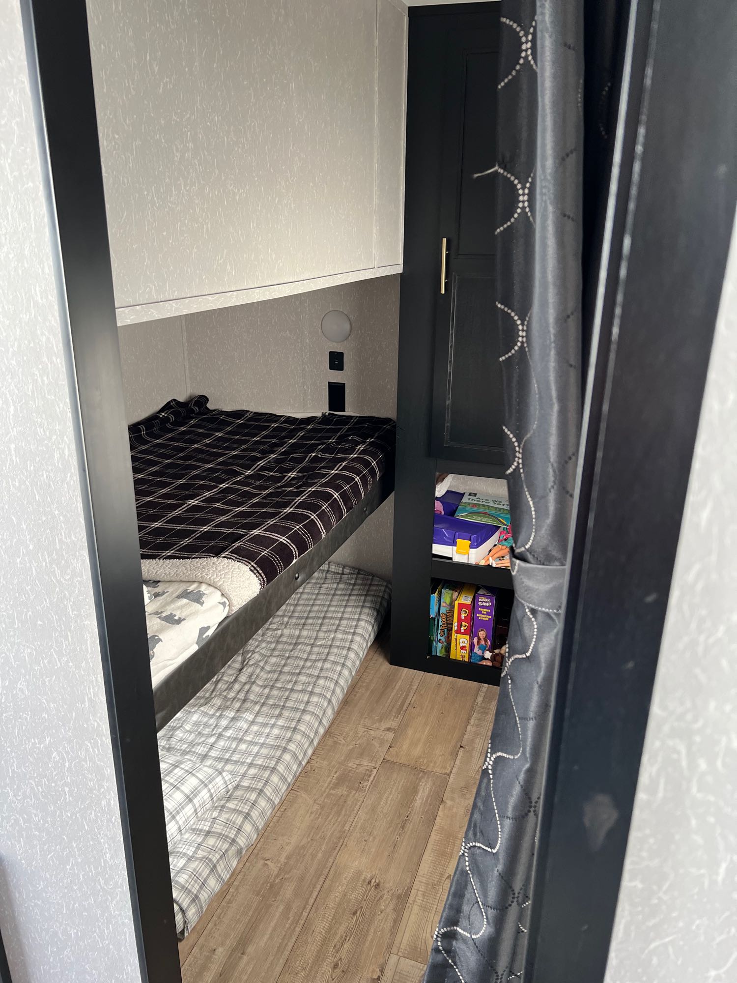 Cozy RV rental bunk beds with built-in storage, perfect for family travel adventures.. Forest River Cherokee Cherokee Black Label 2022