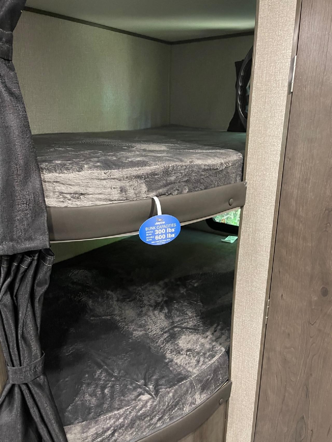 Inside this RV rental, comfortable bunk beds feature safety rails (300 lbs capacity) & privacy curtains. Perfect for camper adventures.. Jayco Jay Flight SLX 2022