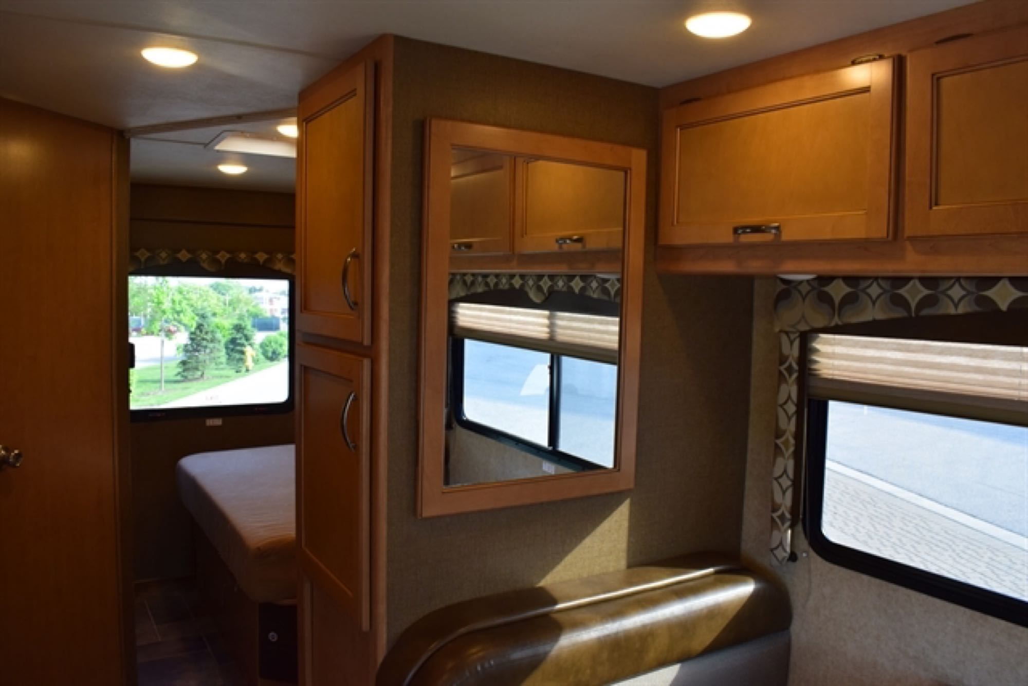 Explore this RV rental's inviting interior: sleeping area, ample storage, and comfortable lounge seating.. Thor Freedom Elite 2016
