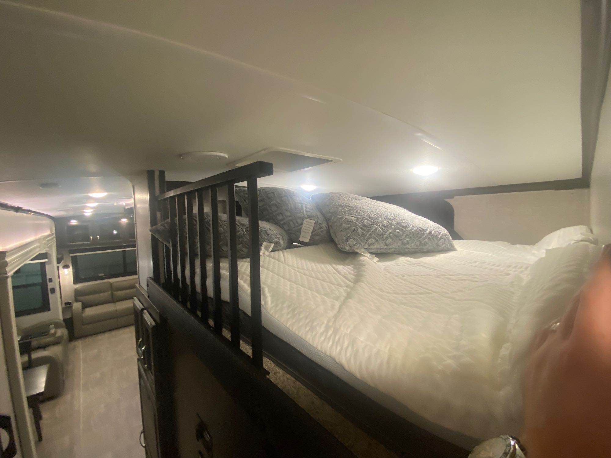 Cozy loft bed in an RV rental, positioned above the main living area, offering a compact and comfortable sleeping space.. Jayco North Point 2022