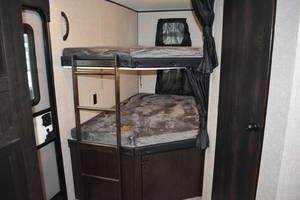Explore comfort with an RV rental! Interior view of cozy bunk beds, complete with mattresses and a ladder for easy access.. Jayco Jay Flight 2023