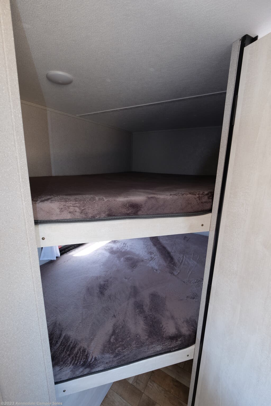 Experience comfort in your RV rental with these cozy bunk beds. The two beds feature plush, dark mattresses.. Shasta 25RS 2022
