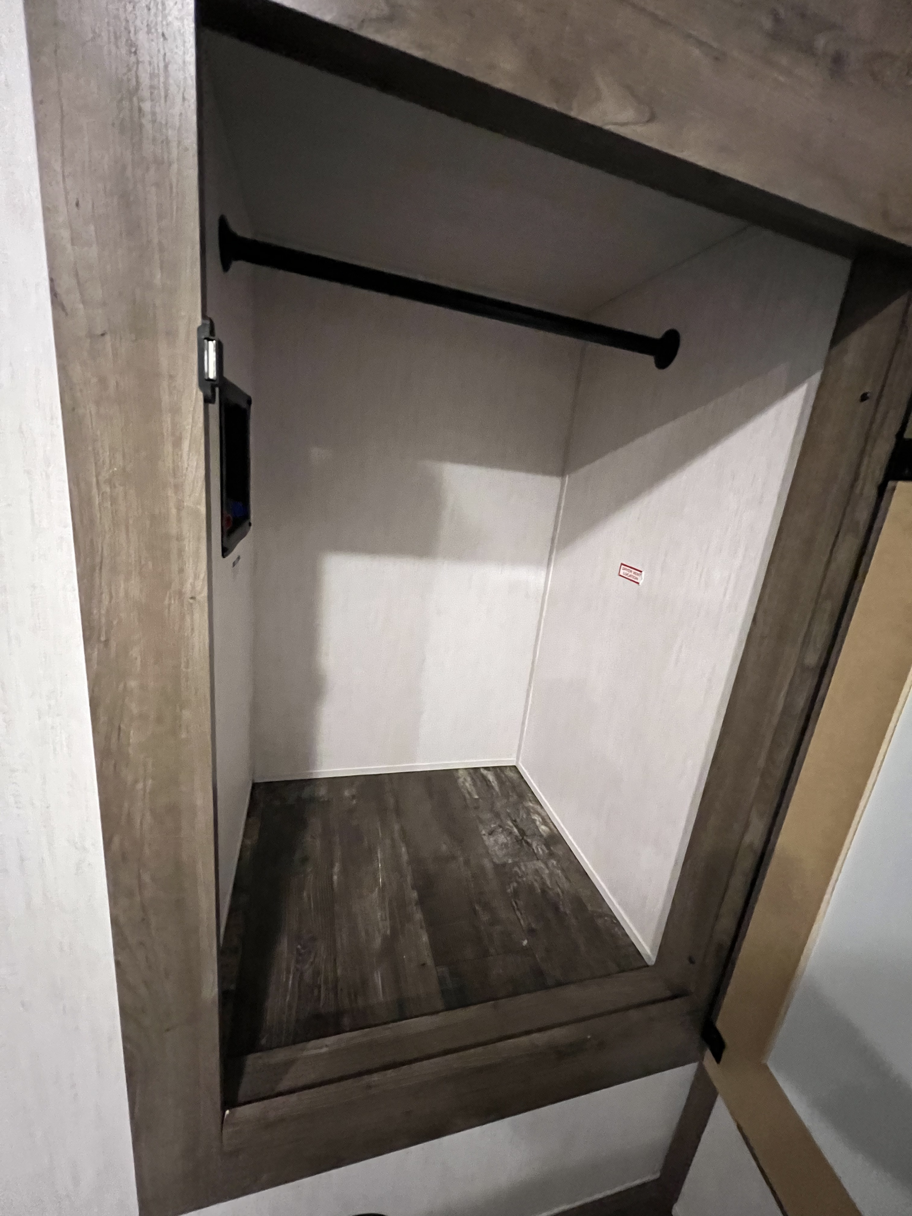 Spacious RV rental wardrobe with hanging rod & wood-look floor, ideal for your travel storage needs.. Forest River Sabre 2021