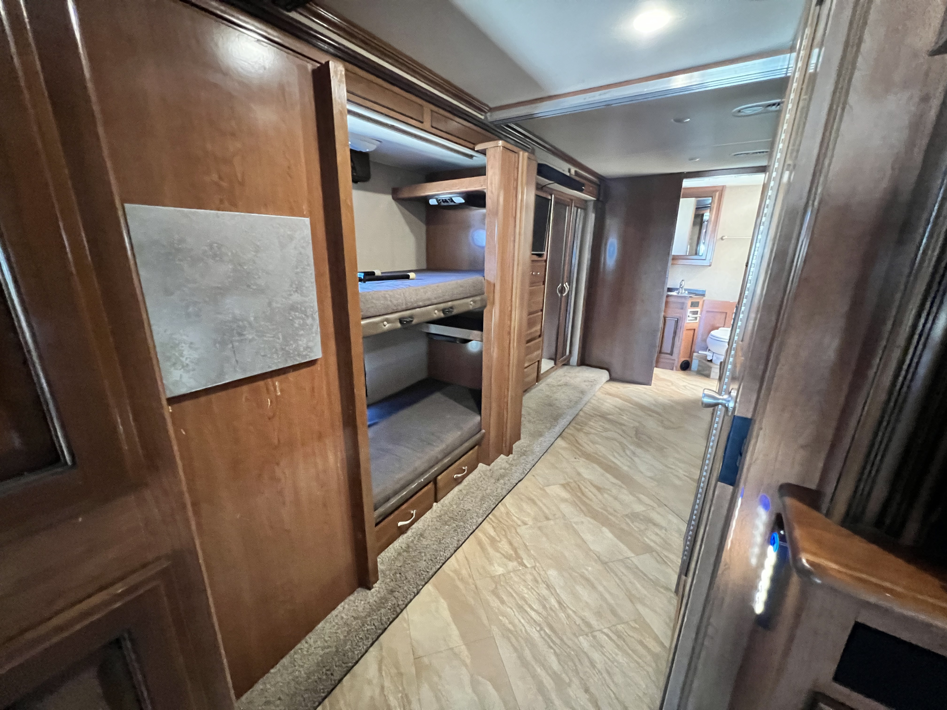 Explore this RV rental's interior: a comfortable bunk bed sleeping area, practical storage, and a well-equipped bathroom.. Fleetwood Bounder 2018