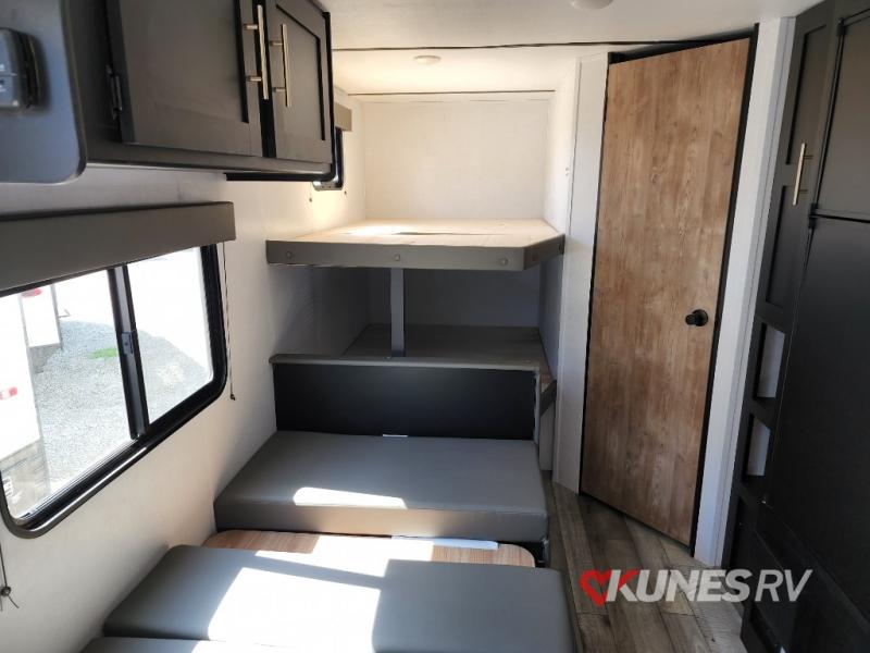 RV rental interior: View of bunk beds, convertible seating, and overhead cabinets. Ideal for a family's sleeping area.. Keystone Springdale 2022
