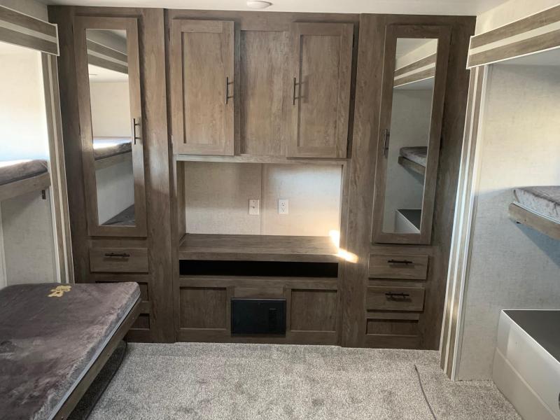 This RV rental bunkhouse features a clever built-in storage unit, mirrored cabinets, and comfortable bunk beds for travelers.. Forest River Salem 2021