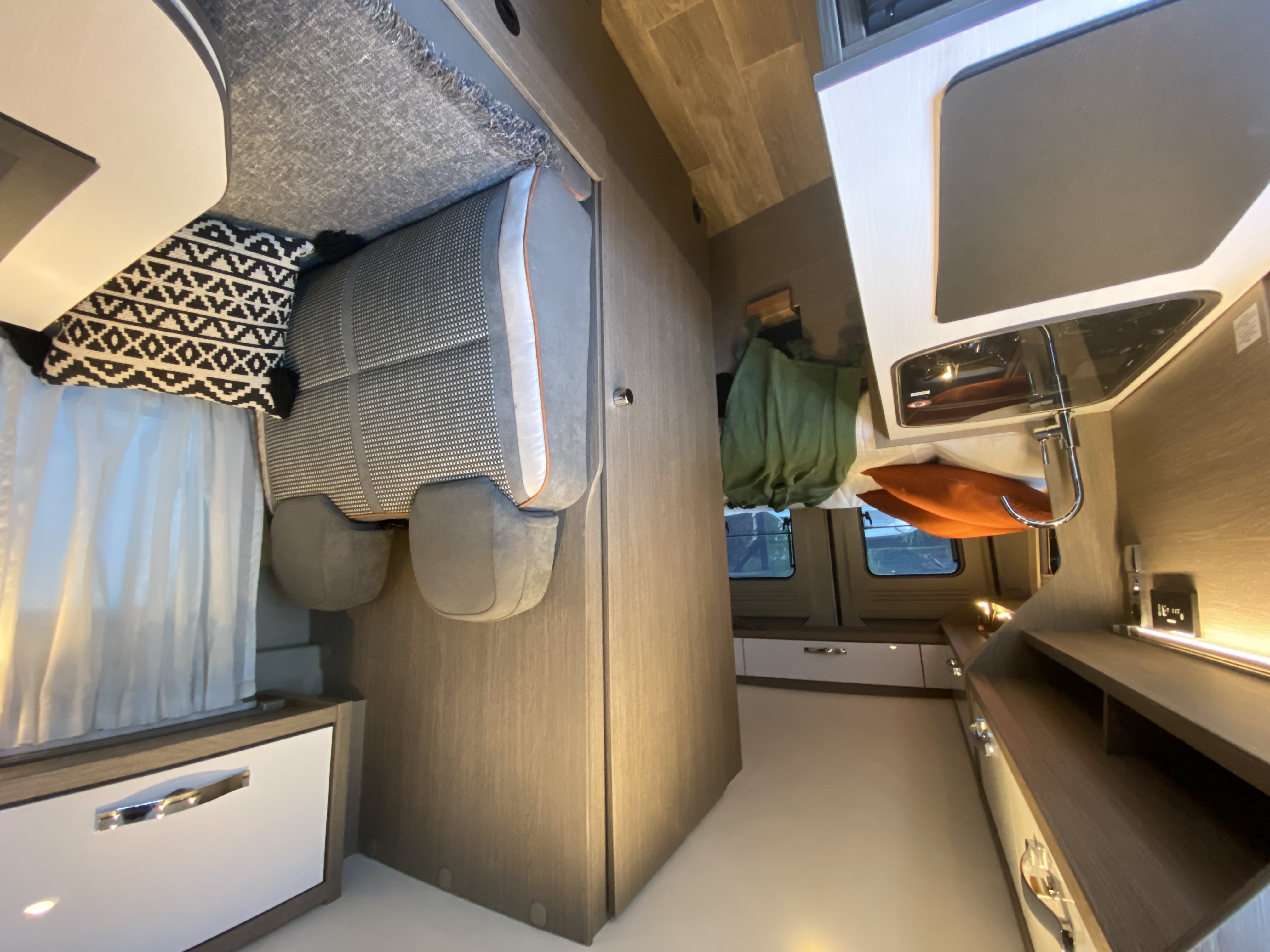 Explore this stylish RV rental interior! Featuring a cozy seating area, compact kitchen, and ample storage for your journey.. Citroen Jumper 2022