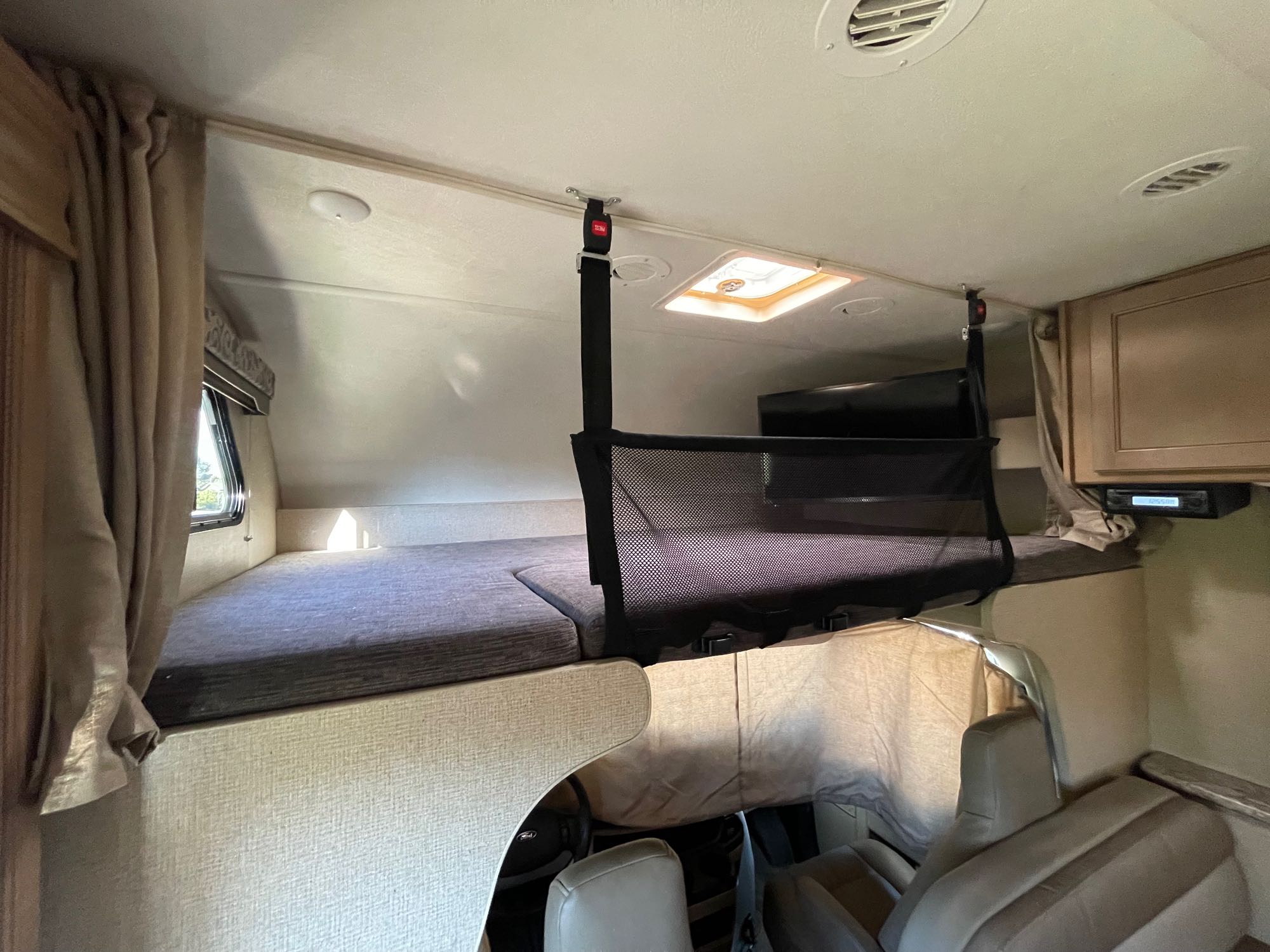 Cab over bed with window and TV. . Thor Motor Coach Four Winds 2020