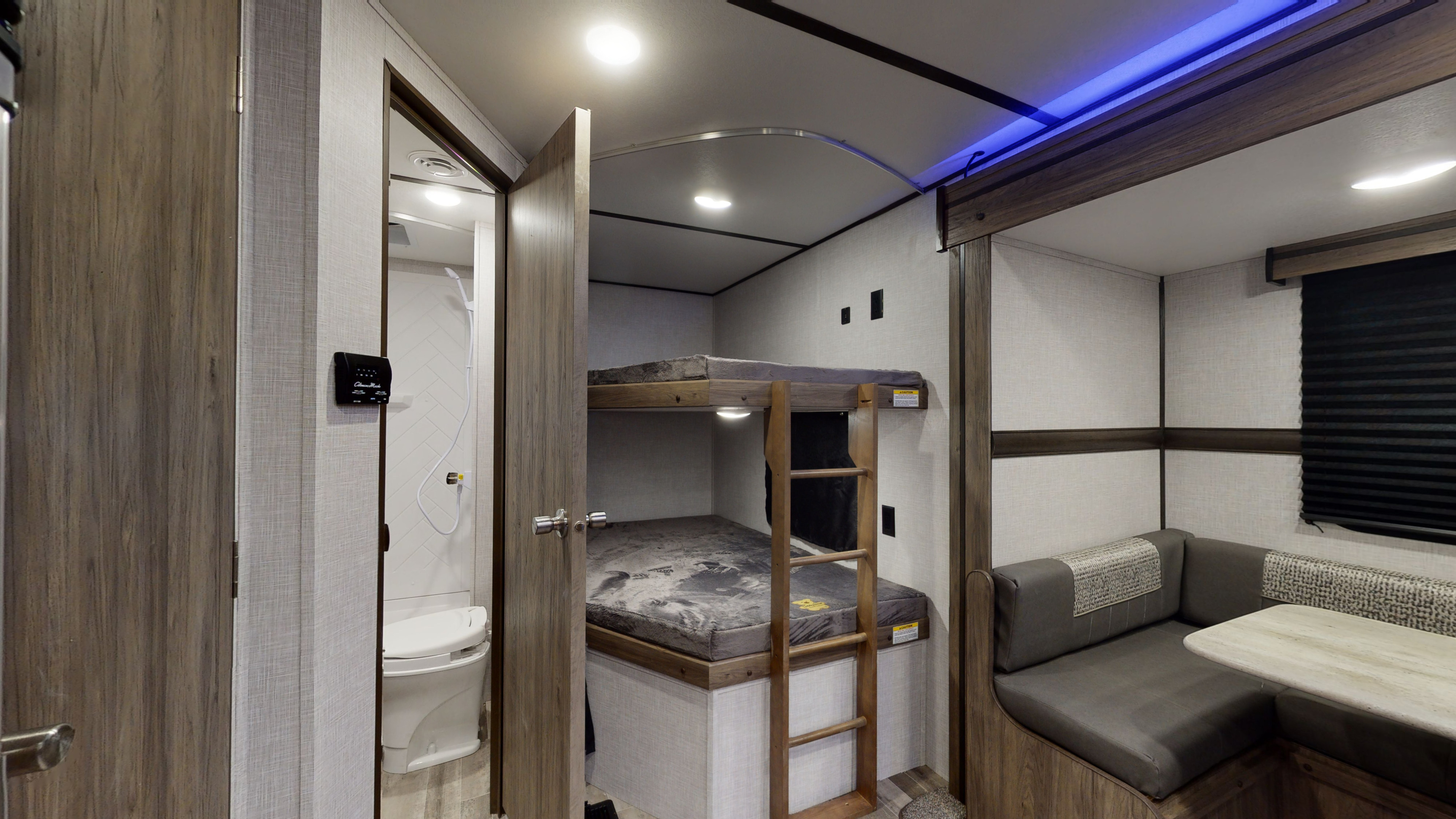Inside this RV rental: functional bunk beds, a compact bathroom, and an L-shaped dinette area for comfortable travel.. Crossroads Zinger 2022