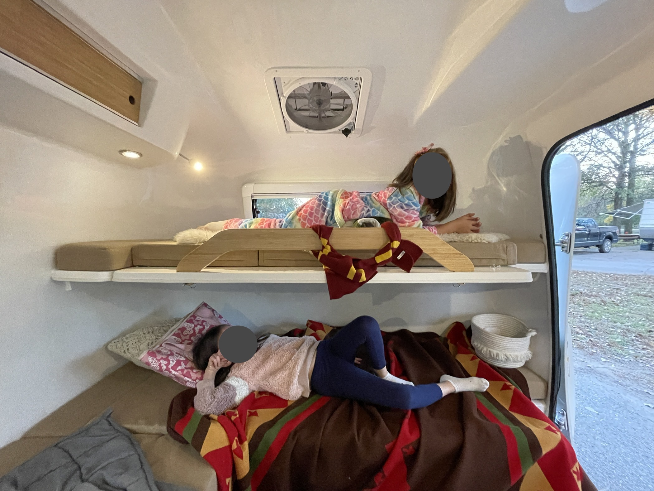 Kids enjoy cozy bunk beds in this RV rental. Perfect for family camping and travel adventures.. Happier Camper HC1 2021