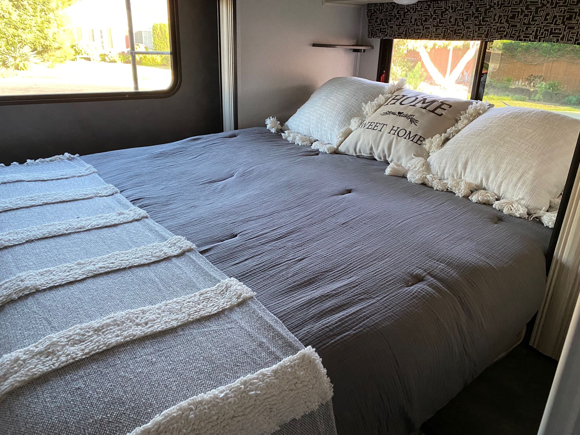 Comfortable Queen bed slides out with the touch of switch. Convenient shelves with cup holders on both walls of the bed.. Forest River Sunseeker 2021