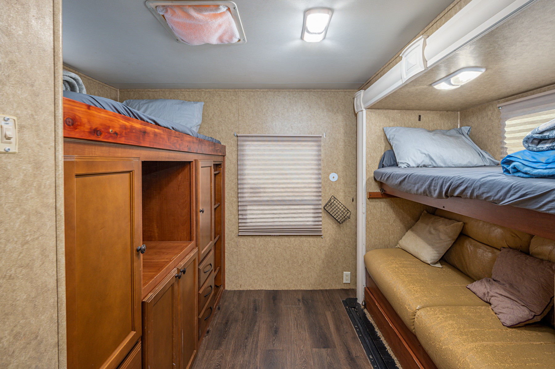 RV rental interior featuring cozy bunk beds and a sofa for comfortable family trips.. Heartland RVs North Trail 2013