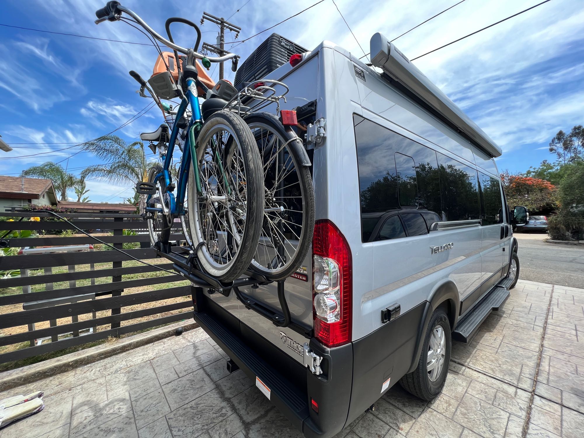 Silver RV rental with bike rack and two bikes, ready for a road trip adventure.. Thor Motor Coach Tellero 2022